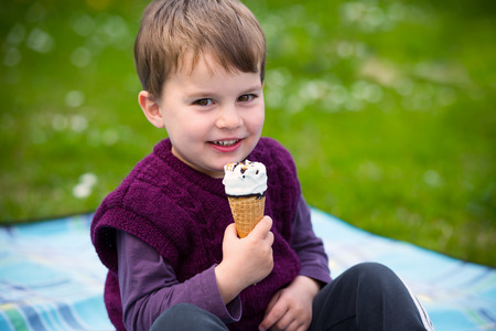 Child eating ice cream outdoorsの写真素材