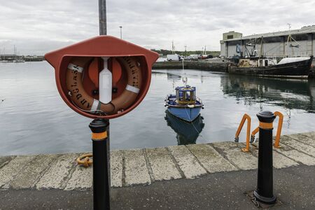 Life buoy, life saving equipment, harbor Ardglass, Northern Irelandの写真素材