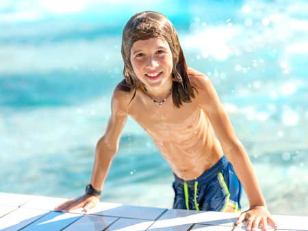 Child playing in the pool on a sunny dayの写真素材