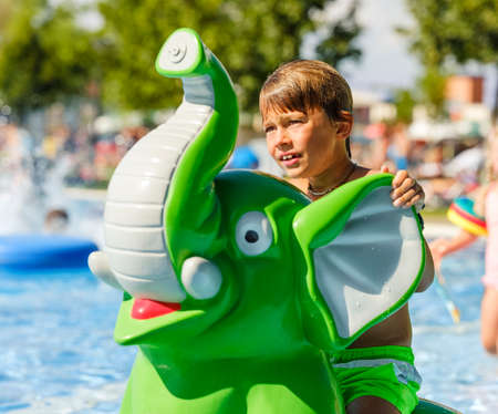 Child playing in the pool on a sunny dayの写真素材