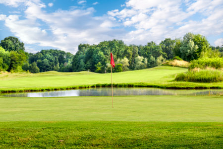 Putting green with a flag at a golf course on a summer dayの写真素材