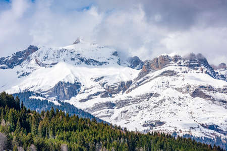 Mont Blanc massif nestled in the clouds on a winter day. Mont Blanc massif chain seen from the French side.の写真素材