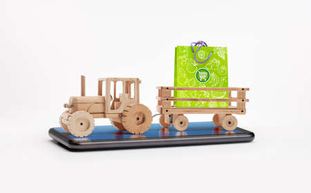 Wooden tractor with trailer, carries a paper bag for fruit and vegetable shopping. Zero km sales concept. Concept of savings and discounts. Online sale concept. Goods for sale.の写真素材