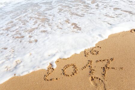 Happy New Year 2017 replace 2016 text on the sea beachの写真素材