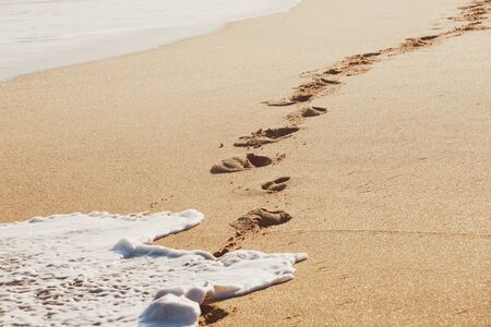 Footsteps on the beautiful  beachの写真素材