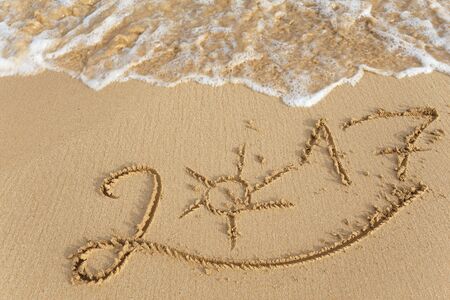 Happy New Year 2017 replace 2016 text on the sea beachの写真素材
