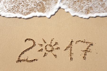 Happy New Year 2017 replace 2016 text on the sea beachの写真素材