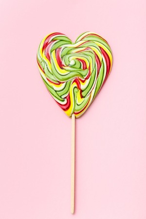 Lollipops valentines day, heart, love. Candy, top view flat lay on pink background. Concepts about decoration, food background.の写真素材