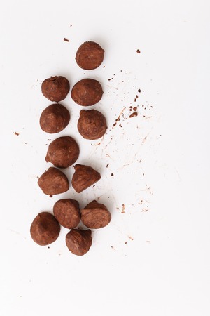 Truffles pattern, top view flat lay of various chocolate sweets. Concepts about decoration on white food backgroundの写真素材