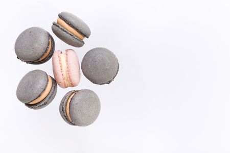 Colorful macarons cake, top view flat lay, fly falling sweet macaroon on color white isolated background. Minimal concepts falling macaroons pattern above, food backgroundの写真素材