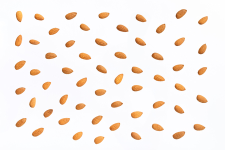 Nuts pattern - almonds on white background. Concepts about decoration, healthy eating and food background.の写真素材