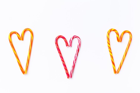 Pattern candy cane on white background, top view flat lay. Sweet sucker, lollipop, candy, isolated minimal concept above decoration, food backgroundの写真素材