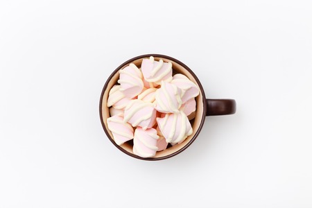Sweet marshmallow in cup, candy on white background, top view flat lay. Isolated minimal concept above decoration, view white marshmallow, food backgroundの写真素材