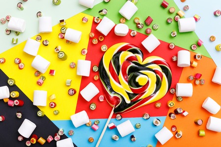 Fruits sweets lollipops, heart and smile. Candy, top view flat lay, pattern on colorful background. Sweet sucker, lollipop, candy, isolated minimal concept above decoration, food backgroundの写真素材