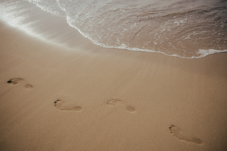Footsteps on the evening beachの写真素材