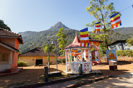 Sri Lanka, Southern Asia - February 14, 2016: Buddhist monk sitting beside the road to the mountain Adams Peak in Sri Lankaのeditorial素材