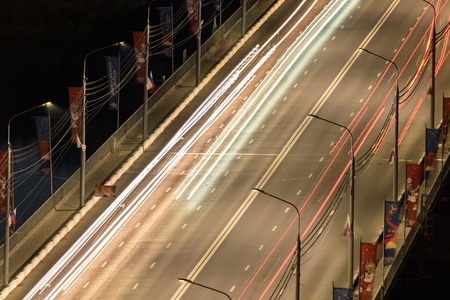 Nizhniy Novgorod / Russia - 06.16.2018: Road bridge across the river. Highway with car light streaks. Long exposure photography.の写真素材