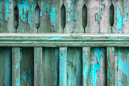 Old wooden fence soiled with peeling blue turquoise paint. Abstract design background.の写真素材