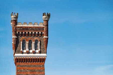 Old abandoned castle tower made of red and white bricks. Picturesque antique construction. Copy space.のeditorial素材