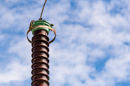 Polymer ceramic insulator with high voltage. Dangerous industrial facility. Close up.
