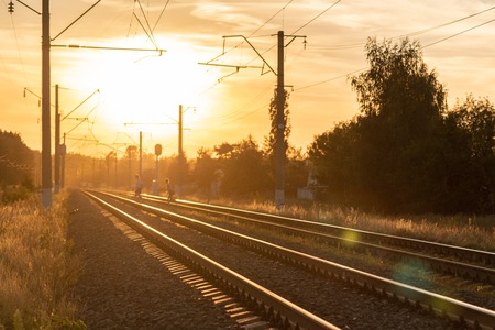 Railway at sunset without train. Beautiful perspective view to railroad.