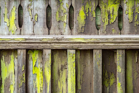 Old wooden fence soiled with peeling green paint. Abstract design background.の写真素材