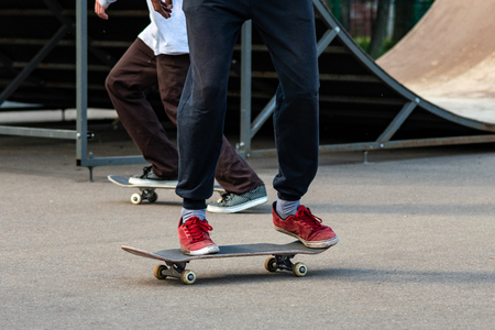 Skater boy performs a trick. Battered and scruffy skateboard.の写真素材