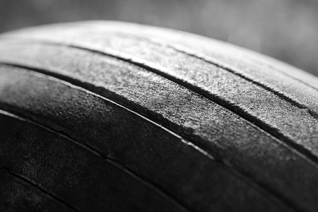 Old tread pattern for vehicle. Car wheel abrasion reduces safety. Close up black and white photoの写真素材