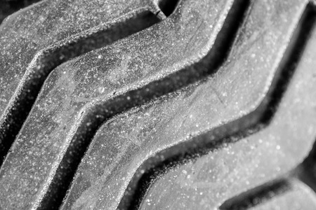 Old tread pattern for vehicle. Car wheel abrasion reduces safety. Close up black and white photoの写真素材