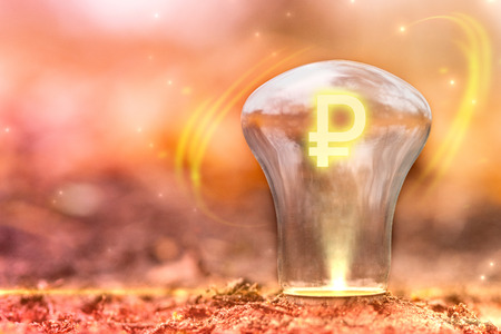 Ruble sign concept with copy space. Currency symbol inside the light bulb. Exchange Rate changes.の写真素材