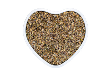 Dill seeds, heart-shaped, close up, isolated. Annual fennel herb used as spice in cooking or for...