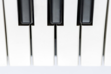 Piano keys close up view. Classical music instrument for playing or composing romantic music. Piano or synthesizer keyboard.の写真素材