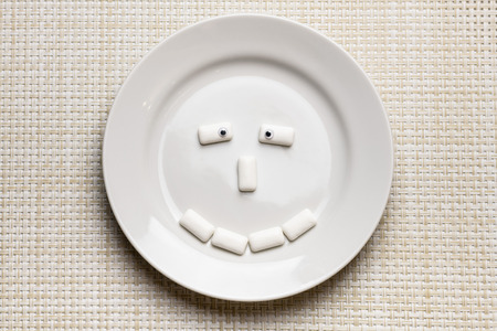 Chewing gum shaped funny face. Oral hygiene and protect teeth from tooth decay or plaque concept....
