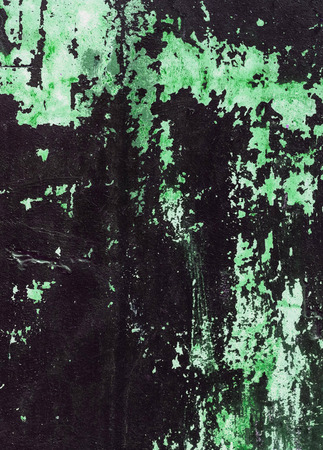 Old concrete wall stained with green paint. Design texture for house interior or wallpapers.の写真素材