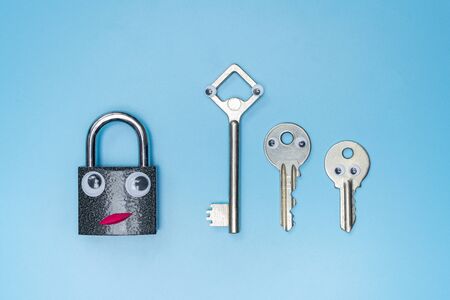 Key and lock funny concept. Dating security or choosing best protection system for rented house, business. Blue background.の写真素材