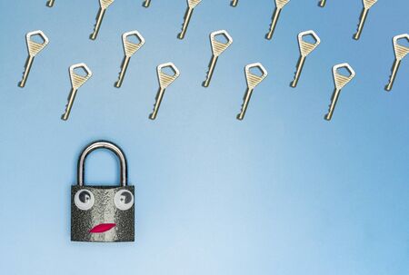 Key rain with lock funny concept, copy space, blue background. Hacking a home or office security system. Information protection and choosing the best solution.の写真素材