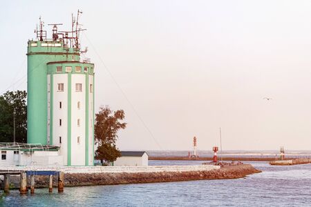 Pilot tower in seaport. Sea traffic control and ships management. Tower for logistic, monitoring wind speed and direction of flow.の写真素材