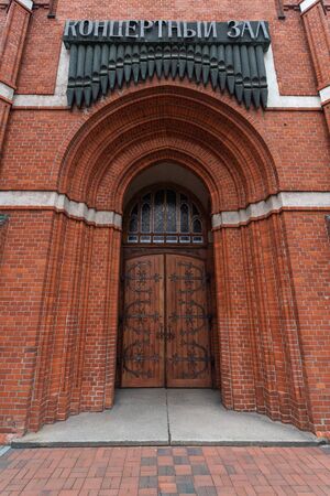 Catholic church of Holy Family in Russia, Kaliningrad city. Neogothic red brick building style. Inscription "Concert Hall".の写真素材