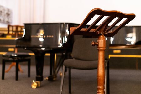 Music stand for paper sheets of music and piano. Before concert in cathedral. Heavy wooden music stand.の写真素材