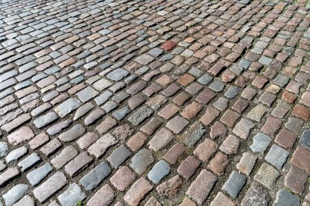 Tiles texture. Pattern of ancient german cobblestone in city downtown. Little granite paving stones....