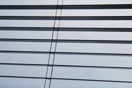 Office blinds. Modern wooden jalousie. Office meeting room lighting range control.の写真素材