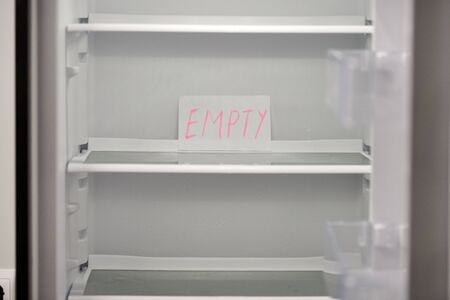 Empty refrigerator concept. Empty shelves of new refrigerator. Weight loss diet concept.の写真素材
