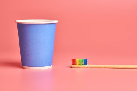 Eco bamboo toothbrush and paper cup. Personal care tool for protect oral cavity, remove plaque and tartar.の写真素材