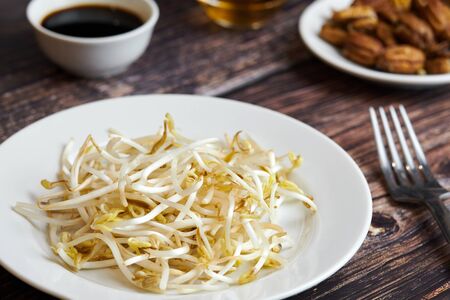 Mung bean sprouts in plate. Raw organic healthy food. Traditional vegetable dish in east Asia.の写真素材