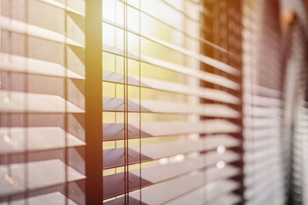 Office blinds. Modern wooden jalousie. Office meeting room lighting range control.の写真素材