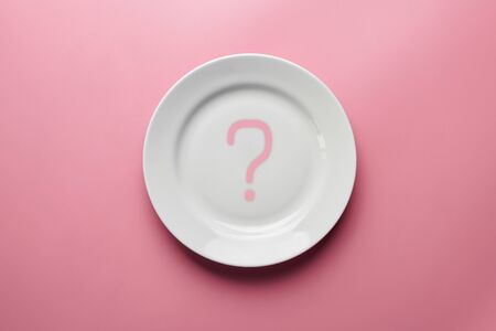 Question mark on empty plate. Diet choice or healthy meals. Vegetarian or meat eating. Waiting for order in restaurant.の写真素材