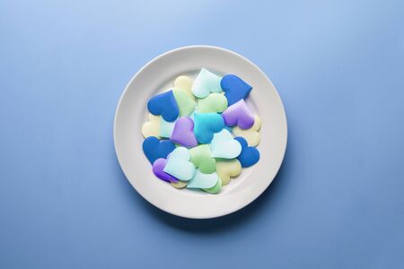 Love hearts in plate. Sex flirt concept. Fall in love in different partners. Pick a new girlfriend or boyfriend. Promiscuity and polygamy concept.の写真素材