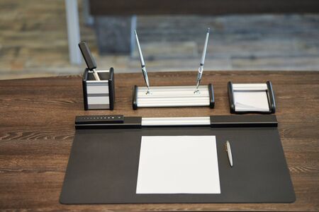 Office workplace with stationery. Boss, chief, supervisor or head of company working place in modern office. Comfortable work table and leather computer chair.の写真素材