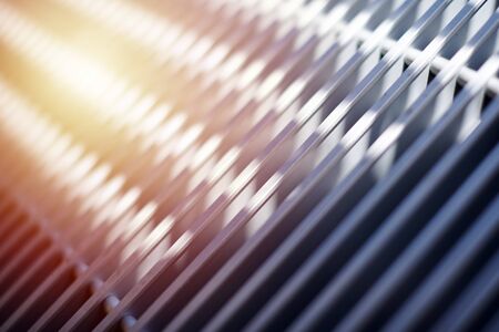 Grill of heating radiator in office, close up. White heat exchangers. Iron aluminium lattice of...