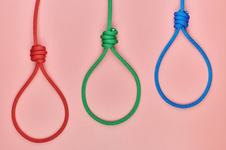 Three hangman's knots. Incitement death penalty concept. Red, green and blue braided hanging noose...